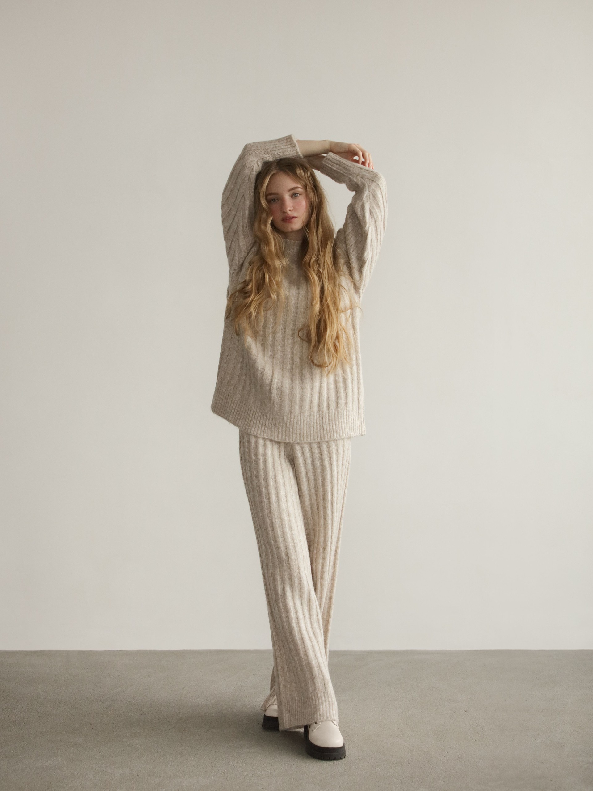 Young beautiful woman wearing knitted sweater and pants